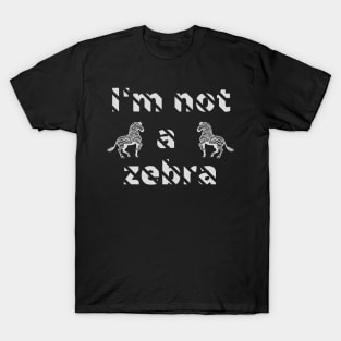 I'm not a zebra. White letters with a mask in the shape of diagonal stripes and two black and white zebras T-Shirt